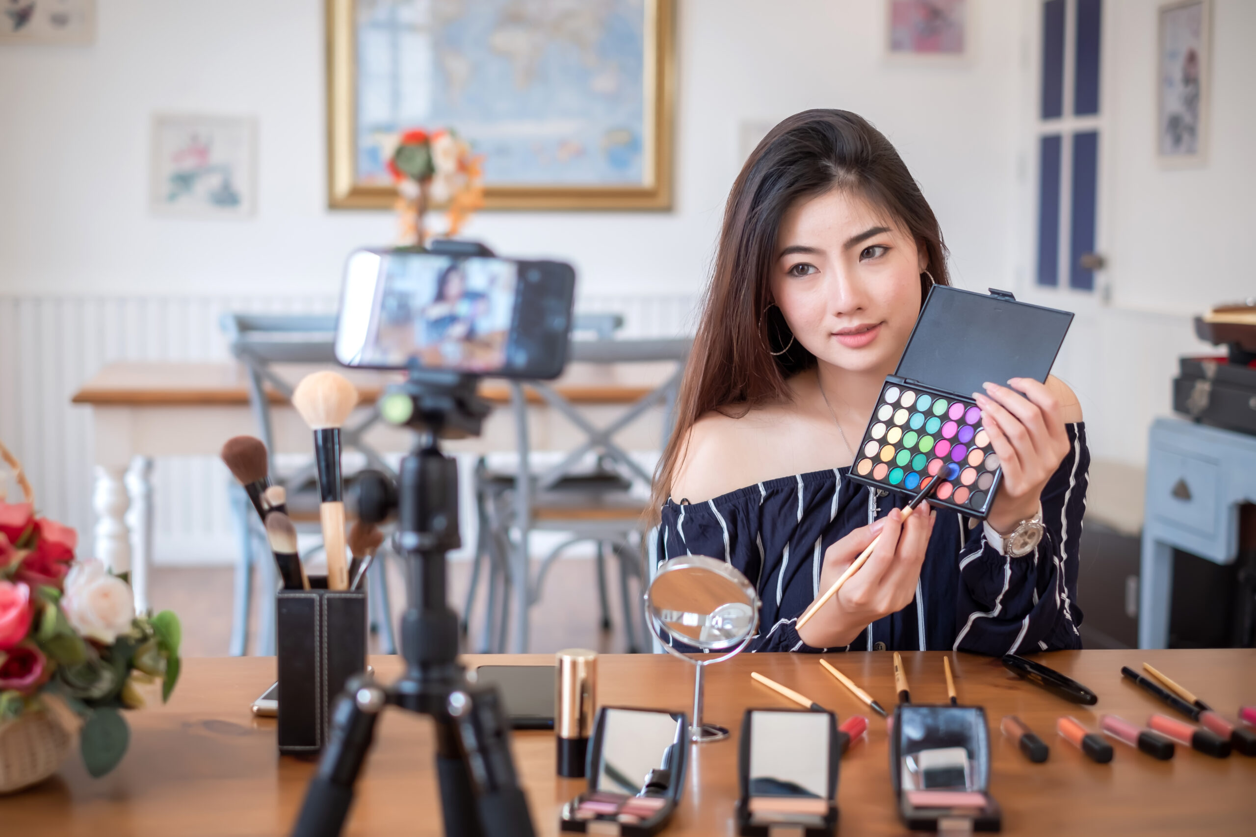 asian woman blogger with makeup cosmetics recording video clip b