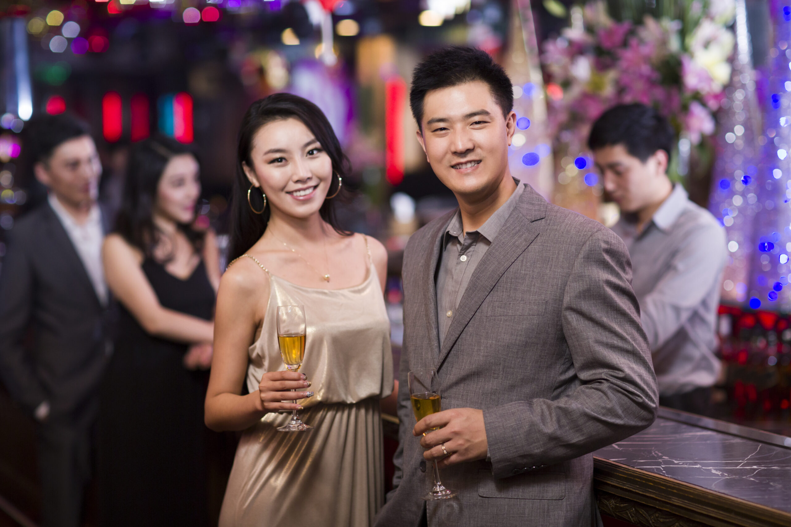 Services cheerful chinese adults drinking alcohol in bar