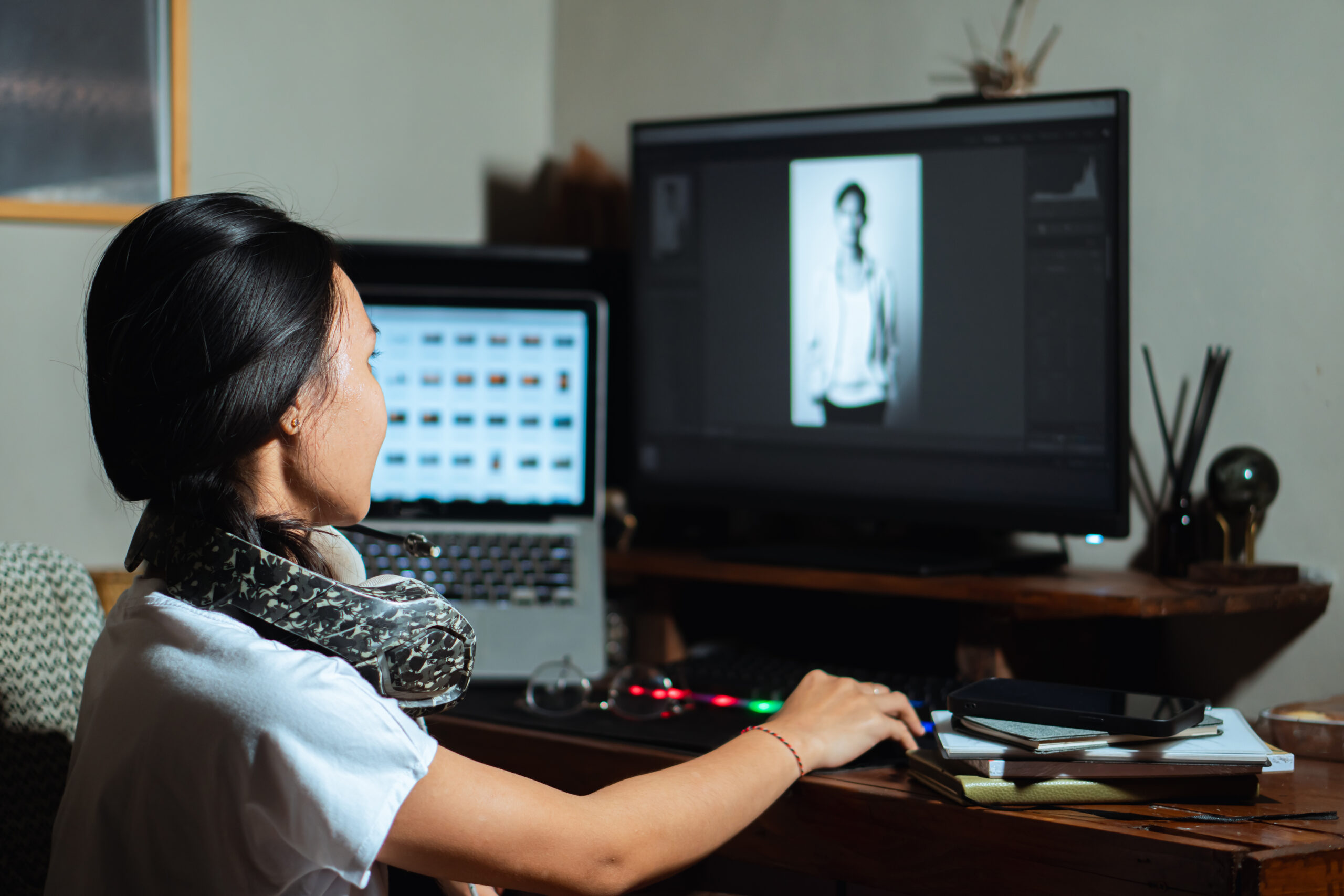Home woman with headphones working on photo editing